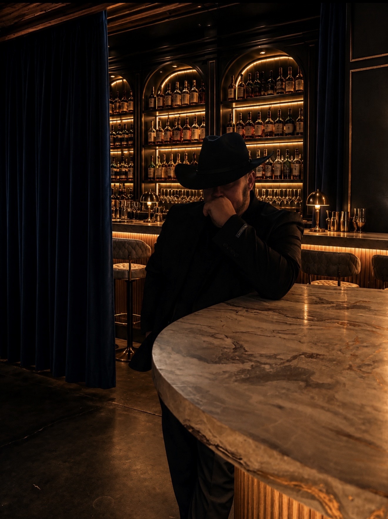 Emad Alayoubi in a cowboy hat at the bar — Whiskey Talks shoot