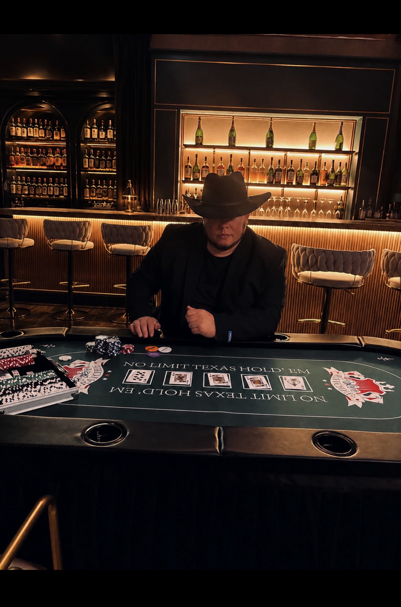 Emad Alayoubi at the poker table in a cowboy hat — Whiskey Talks shoot