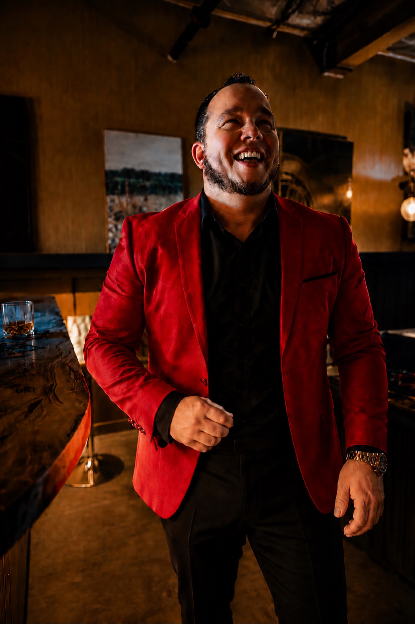 Emad Alayoubi laughing in a red blazer — Whiskey Talks shoot